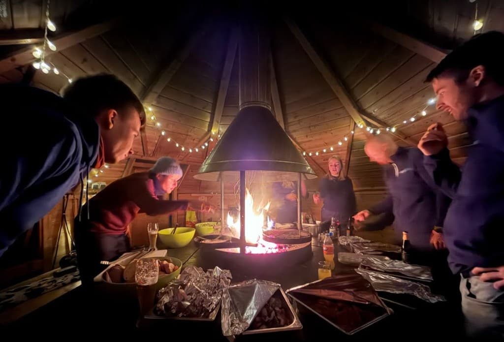 Team cooking together in the grill hut