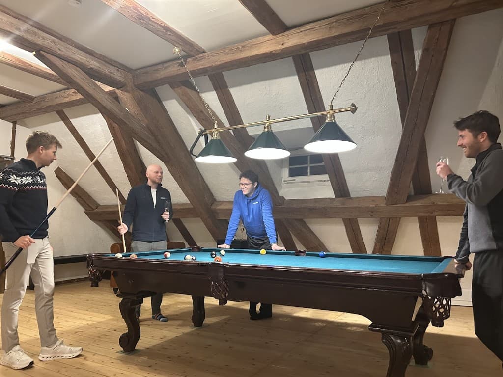 Team playing pool together